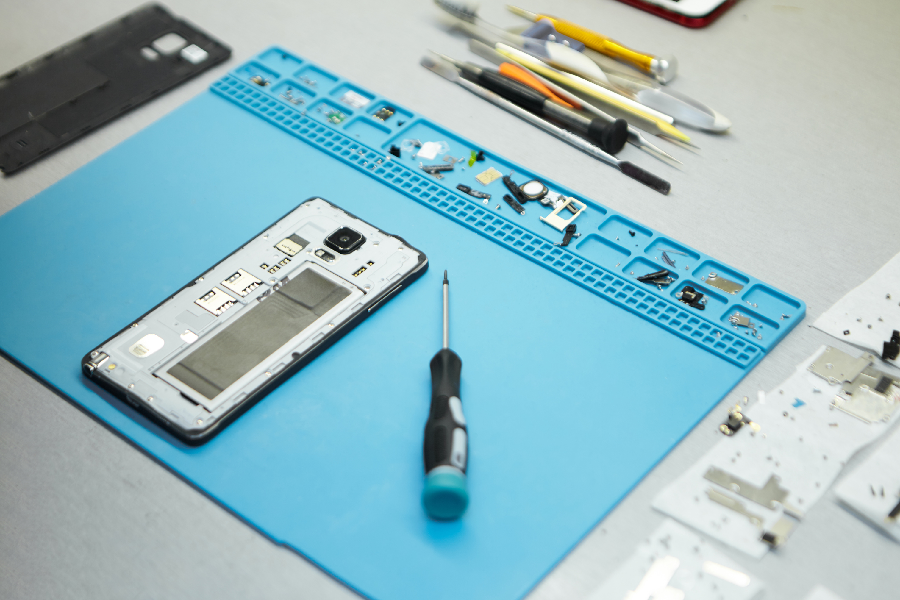 repairman-s-workplace-with-cell-phone-and-special-tools-on-desk.jpg